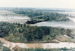 US-Huey-helicopter-spraying-Agent-Orange-in-Vietnam